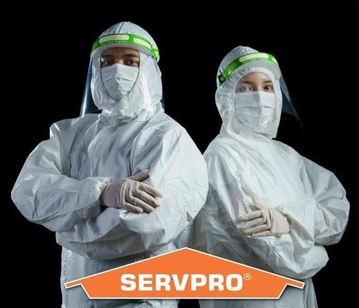 SERVPRO logo and two workers in tyvac suits